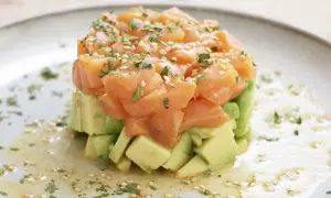 Delicioso tartar de salmón fresco con aguacate, espolvoreado con sésamo y perejil. Una explosión de sabor y color.