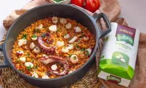 Delicioso arroz con pulpo y gambas en paellera, listo para disfrutar.
