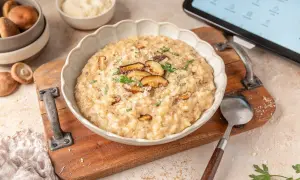 Delicioso risotto de setas hecho en Thermomix, servido en un cuenco blanco con láminas de shiitake y perejil fresco.