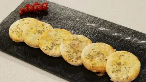 Deliciosas tortas de anís, doradas y crujientes, adornadas con semillas de anís y un toque de frutos rojos.