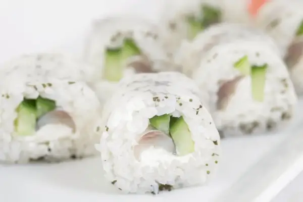 Rollos de sushi con pepino y pescado, listos para disfrutar. Aprende como hacer sushi casero con esta deliciosa receta.